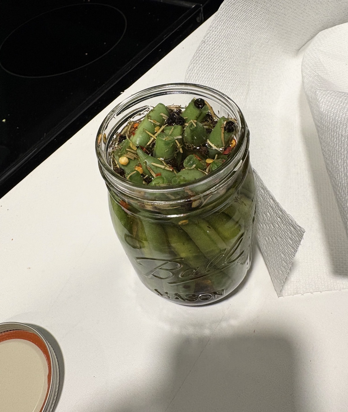Top down close up of a jar of pickled green beans
